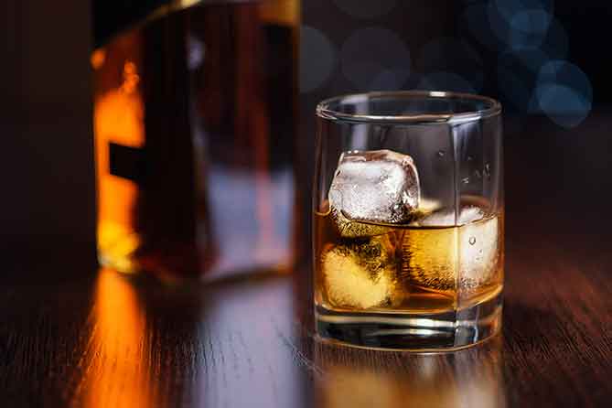 glass of whiskey on bar at Tony Locos
